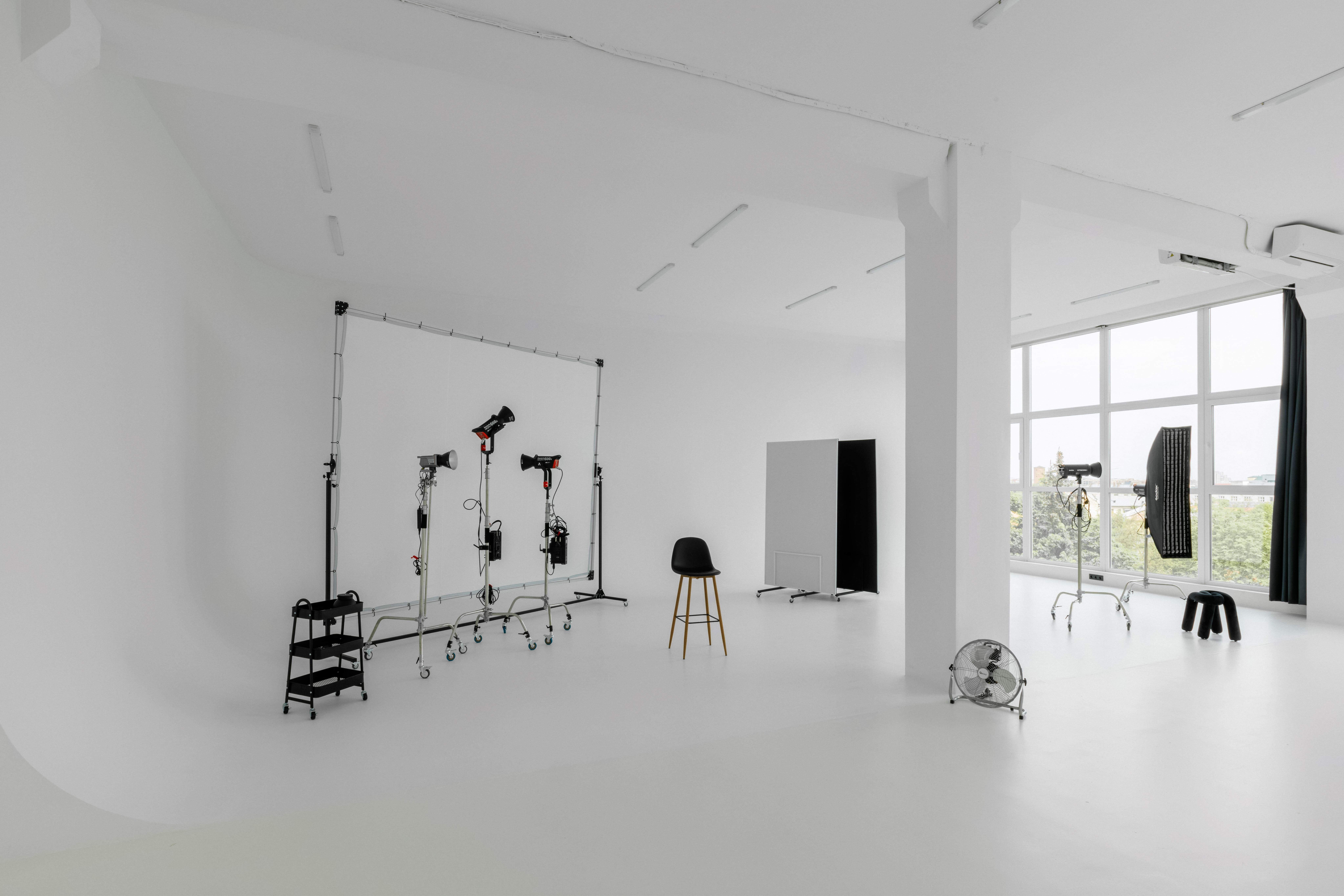 Photographer composing a professional portrait in a thoughtfully arranged studio