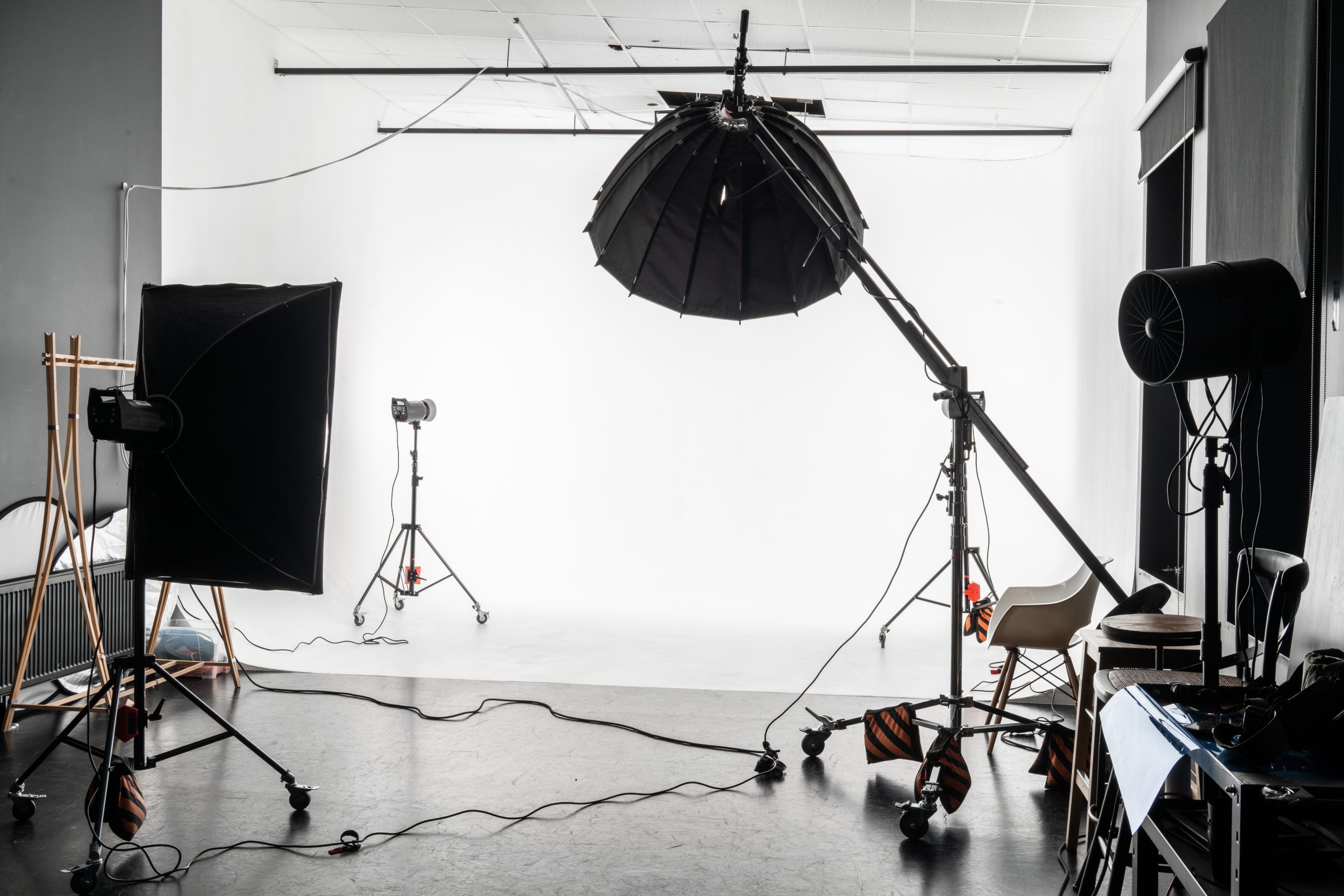 Photographer arranging studio lighting for a professional portrait session